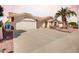 Spacious home featuring a wide driveway, three-car garage, and desert landscaping at 2506 S Acanthus --, Mesa, AZ 85209