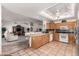 Open concept kitchen and living area with a skylight, tile flooring, and wood cabinets at 2506 S Acanthus --, Mesa, AZ 85209