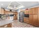 Spacious kitchen with stainless steel refrigerator, tile backsplash, and wooden cabinets at 2506 S Acanthus --, Mesa, AZ 85209