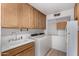 Well-lit laundry room with sink, cabinets, and washer/dryer at 2506 S Acanthus --, Mesa, AZ 85209
