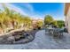 Gorgeous backyard featuring a serene waterfall, lush greenery, and stone patio at 26648 W Quail Ave, Buckeye, AZ 85396