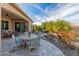 Beautiful outdoor living space with patio table, waterfall feature, and lush landscaping at 26648 W Quail Ave, Buckeye, AZ 85396