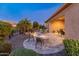 Inviting backyard with fire pit, waterfall, and landscape lighting at 26648 W Quail Ave, Buckeye, AZ 85396