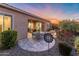 Beautiful backyard patio area with fire pit, waterfall, and comfortable seating at 26648 W Quail Ave, Buckeye, AZ 85396