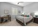 Cozy bedroom with neutral walls, carpet flooring, shuttered windows and a decorative metal bed frame with colorful bedding at 26648 W Quail Ave, Buckeye, AZ 85396