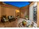 Inviting front courtyard with outdoor seating, decorative pavers, and wrought iron gate at 26648 W Quail Ave, Buckeye, AZ 85396