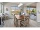 Charming dining area with a wood table, comfortable seating, and bright windows overlooking the backyard at 26648 W Quail Ave, Buckeye, AZ 85396