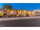 Charming home featuring a tiled roof, two-car garage, desert landscaping, and an arched entryway at twilight at 26648 W Quail Ave, Buckeye, AZ 85396