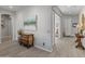 Open foyer featuring stylish flooring, neutral walls, decorative artwork, and arched doorways at 26648 W Quail Ave, Buckeye, AZ 85396