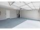 Spacious garage with epoxy flooring, water softener, door to the house and ample room for parking at 26648 W Quail Ave, Buckeye, AZ 85396
