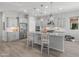 Well-lit kitchen with stainless steel appliances, granite counters, and a spacious central island at 26648 W Quail Ave, Buckeye, AZ 85396