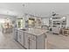 Bright, open kitchen featuring granite counters, stainless appliances, and a large island with pendant lighting at 26648 W Quail Ave, Buckeye, AZ 85396