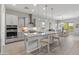 Modern kitchen with granite countertops, stainless steel appliances, and a kitchen island with seating at 26648 W Quail Ave, Buckeye, AZ 85396