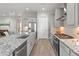Gourmet kitchen featuring stainless appliances, modern cabinets, and an island with a sink at 26648 W Quail Ave, Buckeye, AZ 85396