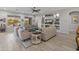 Cozy living area with an entertainment center, multiple seating areas, and well-lit with natural light at 26648 W Quail Ave, Buckeye, AZ 85396