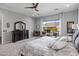 Serene main bedroom featuring a large window, comfortable carpet, and elegant dark wood furniture at 26648 W Quail Ave, Buckeye, AZ 85396