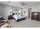 Comfortable main bedroom boasts a ceiling fan, large windows, and stylish decor for a cozy retreat at 26648 W Quail Ave, Buckeye, AZ 85396