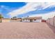 Large backyard featuring gravel landscaping, a covered patio, block fence, and storage shed at 2908 E Escondido Ave, Mesa, AZ 85204