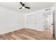 Bedroom features hardwood floors, a modern ceiling fan, and a closet with sliding doors at 2908 E Escondido Ave, Mesa, AZ 85204