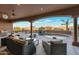 Expansive covered patio with luxurious seating overlooking a pool and scenic views at 29423 N 145Th Pl, Scottsdale, AZ 85262