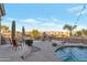 Desert backyard oasis featuring a custom outdoor fireplace with seating area and mountain views at 29423 N 145Th Pl, Scottsdale, AZ 85262