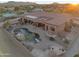 Aerial view of a private backyard oasis featuring a rock waterfall pool and covered patio space at 29423 N 145Th Pl, Scottsdale, AZ 85262