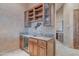 A bar area features custom cabinets, granite counters, mini fridge, and an undermount sink at 29423 N 145Th Pl, Scottsdale, AZ 85262