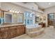 This bathroom features an elegant tub, many windows, and dual sinks at 29423 N 145Th Pl, Scottsdale, AZ 85262