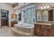 This bathroom features an elegant tub, many windows, and dual sinks at 29423 N 145Th Pl, Scottsdale, AZ 85262