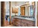 This bathroom features an ornate mirror, dual sinks, and abundant storage space at 29423 N 145Th Pl, Scottsdale, AZ 85262