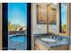 Bright bathroom featuring stone countertop vanity and view of the private pool at 29423 N 145Th Pl, Scottsdale, AZ 85262