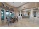 Open-concept dining area adjacent to the kitchen with travertine flooring and architectural columns at 29423 N 145Th Pl, Scottsdale, AZ 85262