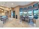 Dining area with large windows and views, bar seating, and neutral color palette at 29423 N 145Th Pl, Scottsdale, AZ 85262