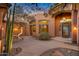 An inviting home entrance boasts an arched walkway and a desert landscaped courtyard at 29423 N 145Th Pl, Scottsdale, AZ 85262