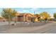 Inviting Southwestern home featuring mature desert landscaping and an attached three car garage at 29423 N 145Th Pl, Scottsdale, AZ 85262
