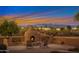 Outdoor fireplace with firewood storage providing a warm ambiance at 29423 N 145Th Pl, Scottsdale, AZ 85262