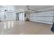 Large garage with epoxy floor, multiple garage doors, and overhead lighting at 29423 N 145Th Pl, Scottsdale, AZ 85262