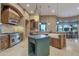 Spacious kitchen featuring a large island, stainless steel appliances, granite countertops, and custom cabinetry at 29423 N 145Th Pl, Scottsdale, AZ 85262