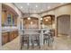 Spacious kitchen featuring custom cabinetry, a large island, and travertine floors at 29423 N 145Th Pl, Scottsdale, AZ 85262