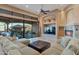Spacious living room featuring a fireplace, comfortable seating, and backyard views at 29423 N 145Th Pl, Scottsdale, AZ 85262