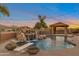 Backyard oasis with a pool, diving board, waterfall, and outdoor cabana at 29423 N 145Th Pl, Scottsdale, AZ 85262