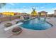 Beautiful pool area featuring rock waterfall, diving board, and lush landscaping at 29423 N 145Th Pl, Scottsdale, AZ 85262