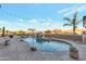 Sparkling pool with rock waterfall feature, lush landscaping, and mountain views at 29423 N 145Th Pl, Scottsdale, AZ 85262