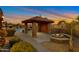 Backyard pool area with a cabana, fire pit, and lush landscaping at 29423 N 145Th Pl, Scottsdale, AZ 85262