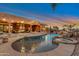 Backyard pool and spa with rock waterfall feature against desert sunset at 29423 N 145Th Pl, Scottsdale, AZ 85262
