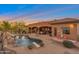 Luxury backyard with outdoor seating, pool, and a rock waterfall at 29423 N 145Th Pl, Scottsdale, AZ 85262