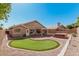 Private backyard with a putting green, hot tub, and covered patio, perfect for outdoor enjoyment at 4102 E Cathedral Rock Dr, Phoenix, AZ 85044