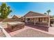 Beautiful backyard featuring a hot tub, covered patio, and views of the home's exterior at 4102 E Cathedral Rock Dr, Phoenix, AZ 85044