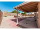 Spacious backyard with a covered patio, a gravel area, and a wooden hot tub for relaxation at 4102 E Cathedral Rock Dr, Phoenix, AZ 85044