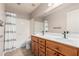 Bathroom showcasing a double sink vanity with wooden cabinetry and a shower-tub combo at 4102 E Cathedral Rock Dr, Phoenix, AZ 85044